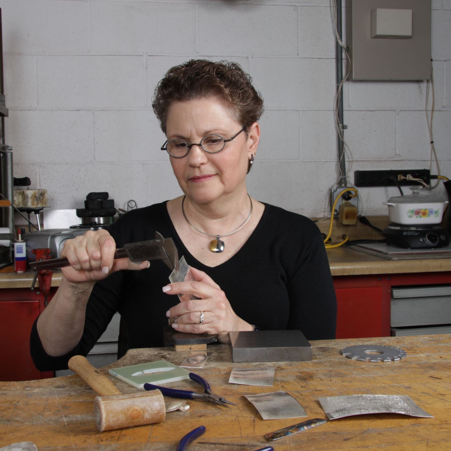 Estelle Vernon at her workbench, creating jewelry that embodies her design mantra of elegant simplicity.
