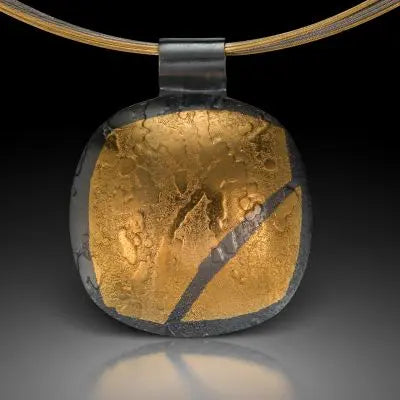 Round oxidized silver pendant with abstract gold Keum Boo inlay on a multi-strand necklace by Estelle Vernon.