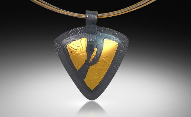 Triangular oxidized silver pendant with gold Keum Boo inlay on a multi-strand necklace by Estelle Vernon.