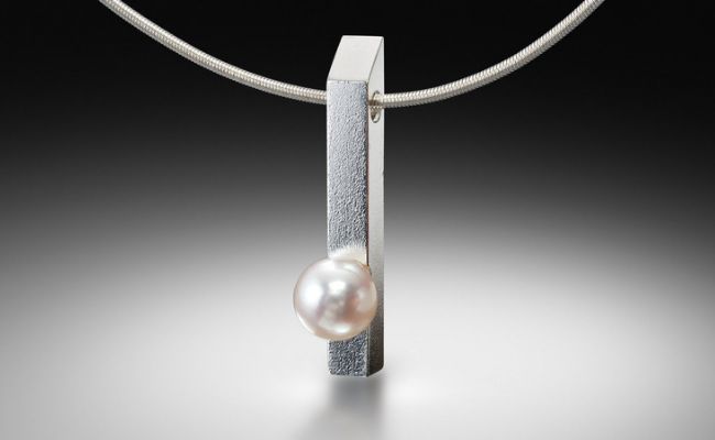 Silver bar pendant with a single pearl on a modern necklace by Estelle Vernon.
