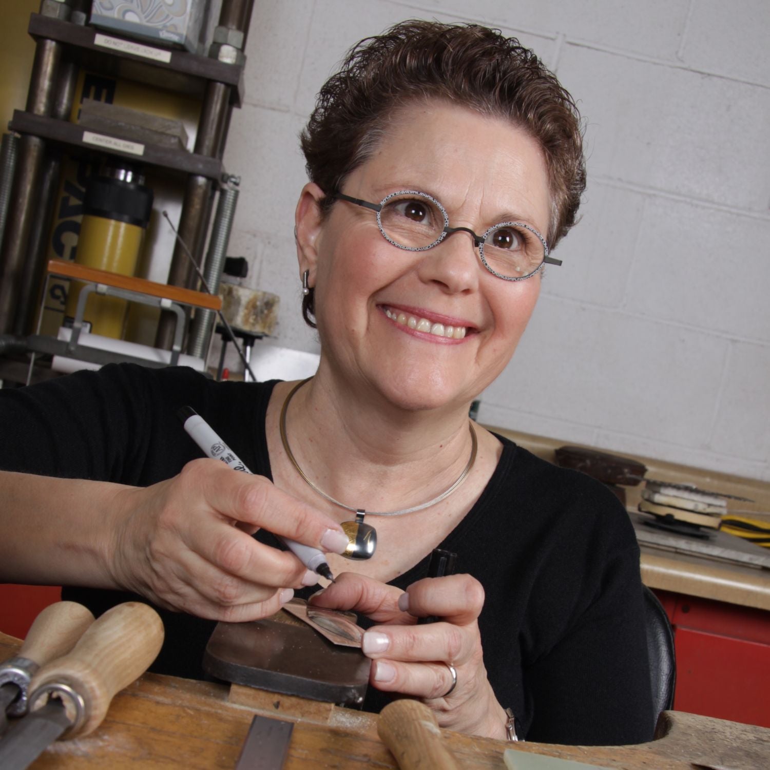 Estelle Vernon, once more at her bench, crafting wearable art with meticulous care.